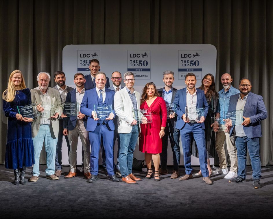 Group of professionals at 'The Top 50 Awards LDC 2023', holding awards on stage.